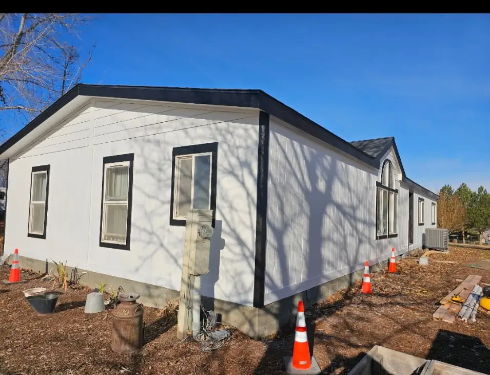 After: new white siding with black trim