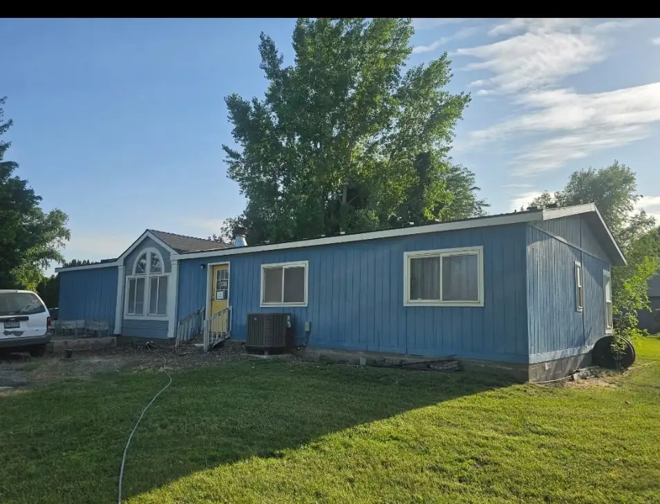 Before: weathered blue siding, original windows
