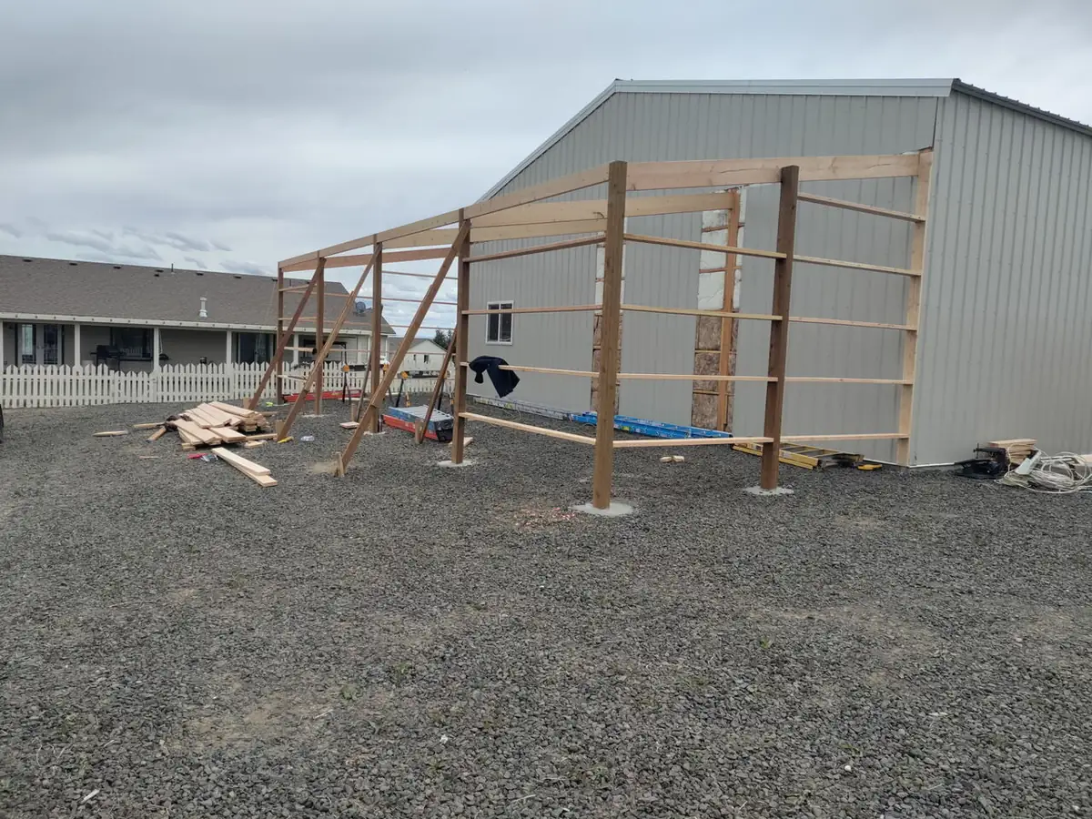 Before: pole barn wood framing against metal building