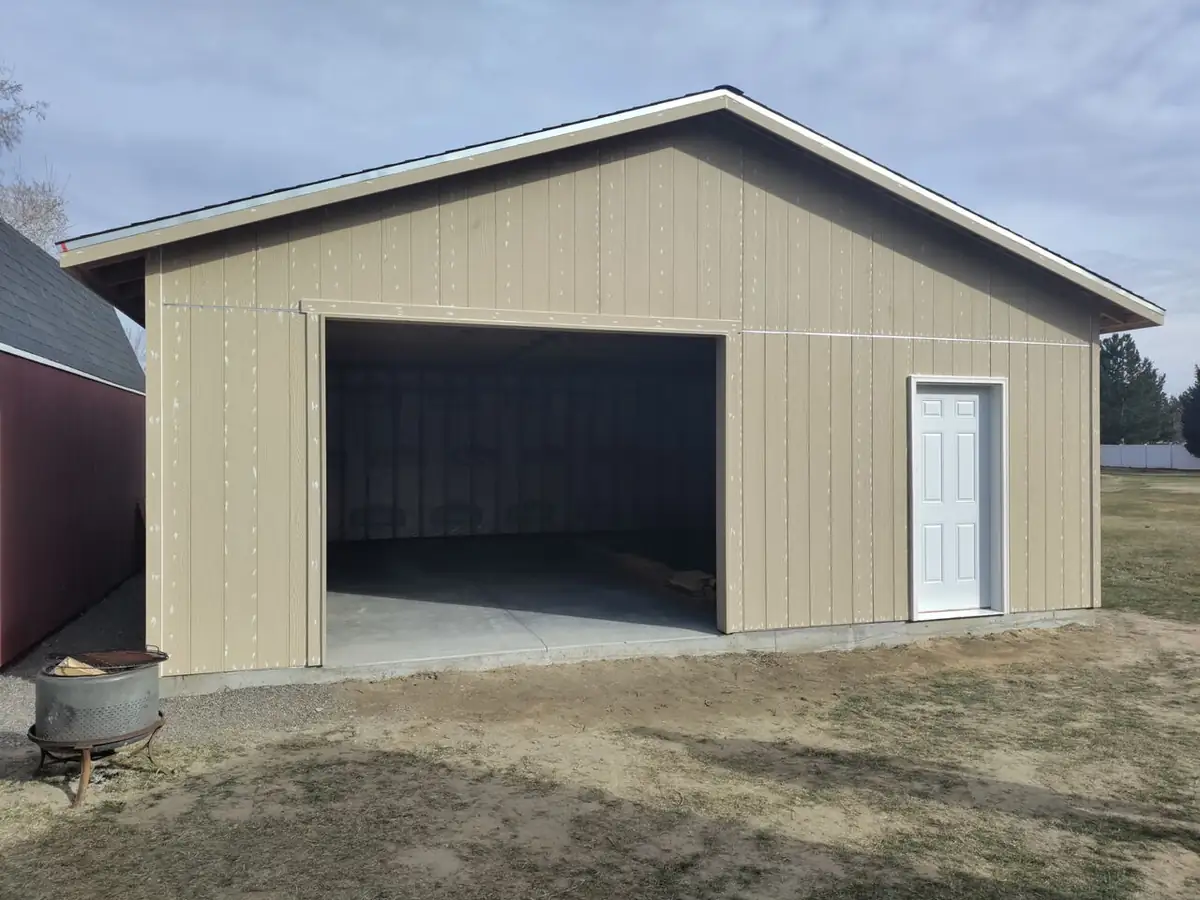 After: finished detached garage with siding and entry door